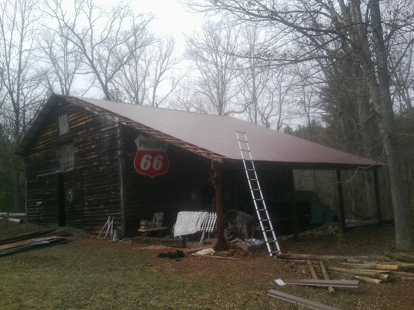 New metal roof on an open sided timber barn with a vintage sign in Orland